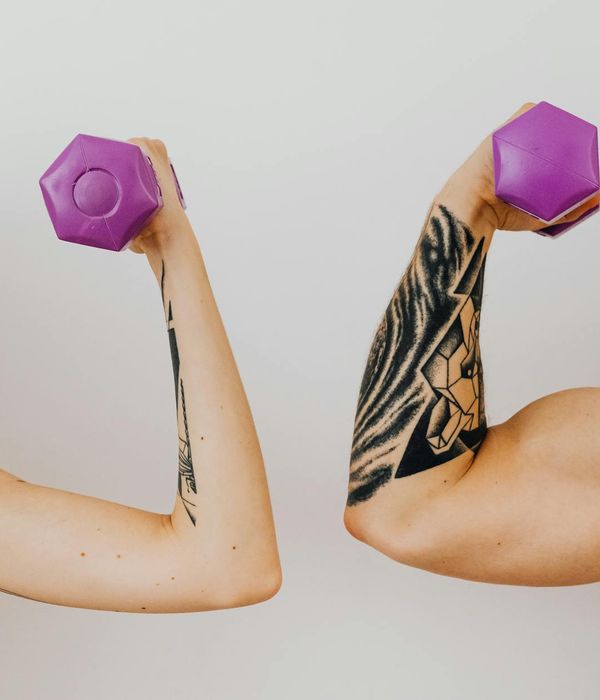 Man performing a powerful bodyweight exercise in a dark gym.